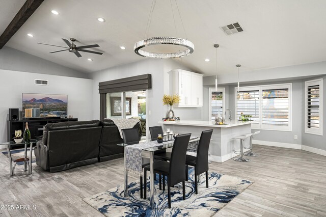 6102 E Nisbet Rd, Scottsdale, AZ 85254 - dining room with plenty of natural light, vaulted ceiling with beams, and light hardwood / wood-style floors