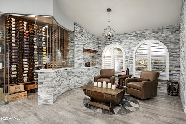 6102 E Nisbet Rd, Scottsdale, AZ 85254 - wine room featuring an inviting chandelier, lofted ceiling, and light hardwood / wood-style floors