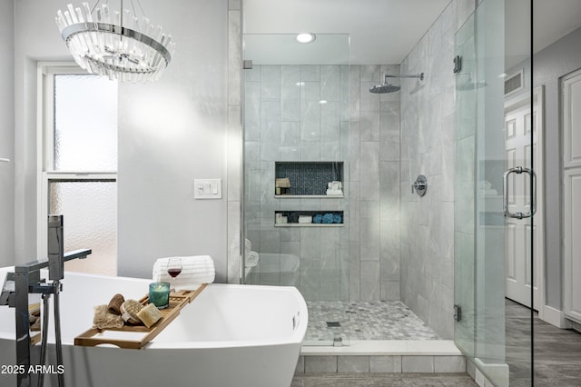 6102 E Nisbet Rd, Scottsdale, AZ 85254 - bathroom featuring wood-type flooring, plus walk in shower, and a chandelier