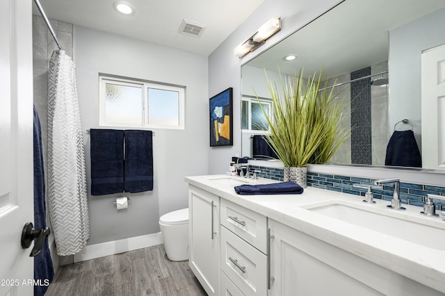 6102 E Nisbet Rd, Scottsdale, AZ 85254 - bathroom with hardwood / wood-style floors, backsplash, vanity, toilet, and a shower with shower curtain