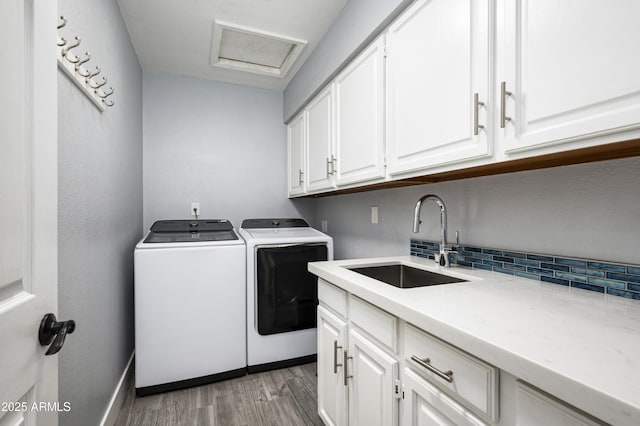 6102 E Nisbet Rd, Scottsdale, AZ 85254 - washroom featuring washer and dryer, sink, cabinets, and light hardwood / wood-style flooring