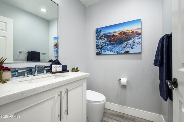 6102 E Nisbet Rd, Scottsdale, AZ 85254 - bathroom featuring wood-type flooring, toilet, backsplash, and vanity