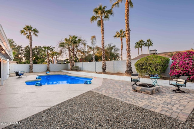 6102 E Nisbet Rd, Scottsdale, AZ 85254 - pool at dusk featuring a patio area and a fire pit