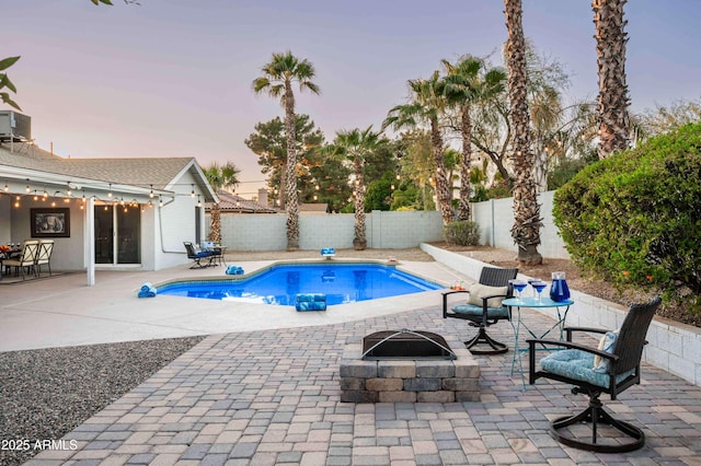 6102 E Nisbet Rd, Scottsdale, AZ 85254 - pool at dusk with a patio, central AC, and a fire pit