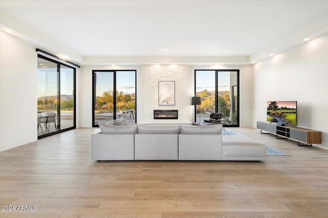 unfurnished living room featuring light hardwood / wood-style floors and a large fireplace