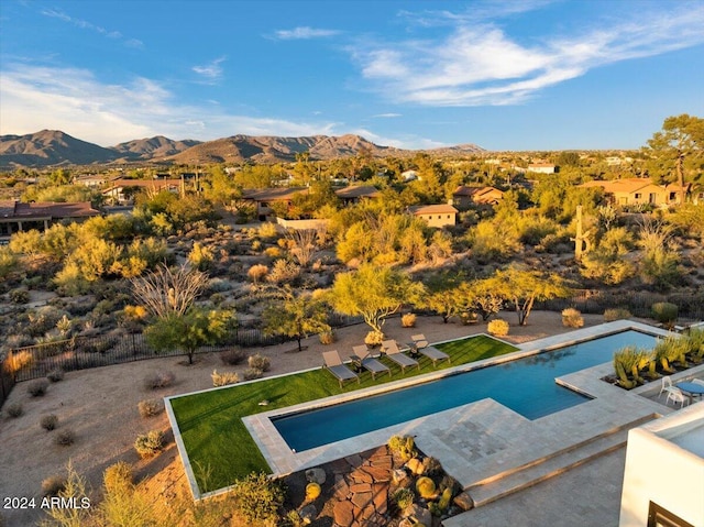 view of pool with a mountain view, a yard, and a patio area