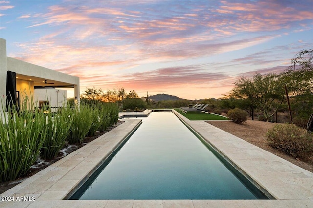 pool at dusk with a mountain view