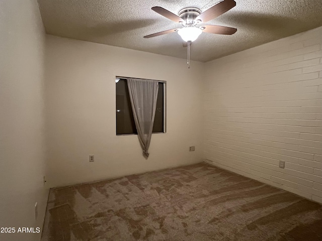carpeted spare room with ceiling fan and a textured ceiling
