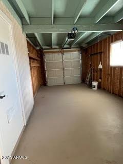 garage featuring wooden walls