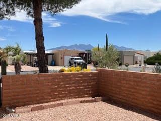 view of yard with a mountain view and fence