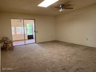 spare room featuring a ceiling fan and carpet floors