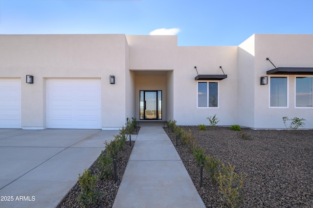 pueblo-style home featuring a garage