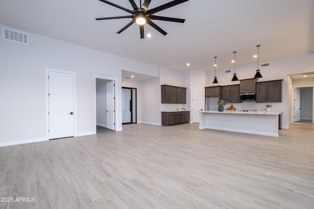 unfurnished living room with ceiling fan