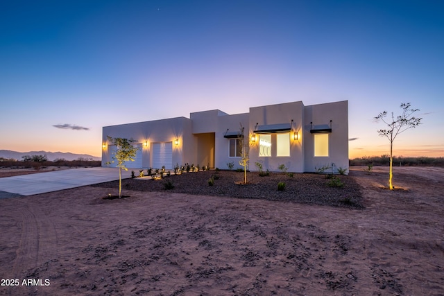 pueblo-style home featuring a mountain view and a garage