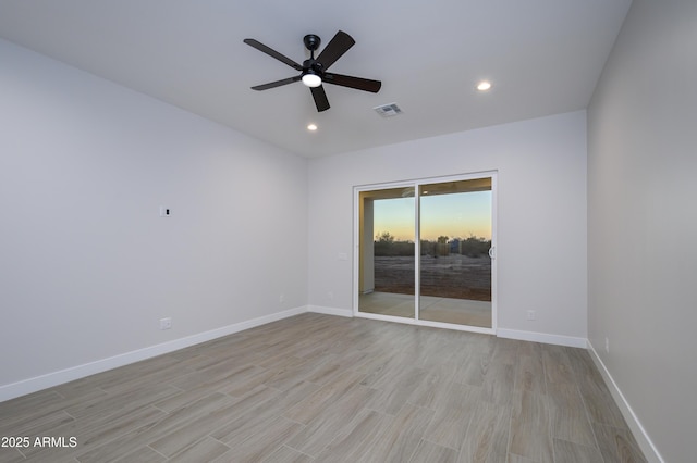 unfurnished room with light wood-type flooring and ceiling fan