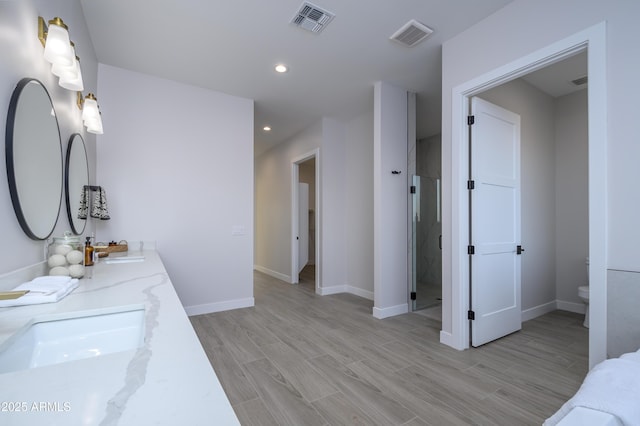 bathroom with vanity, toilet, and walk in shower