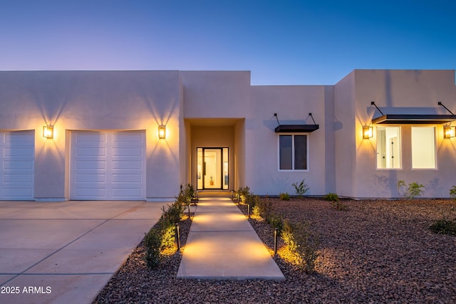 pueblo-style home featuring a garage