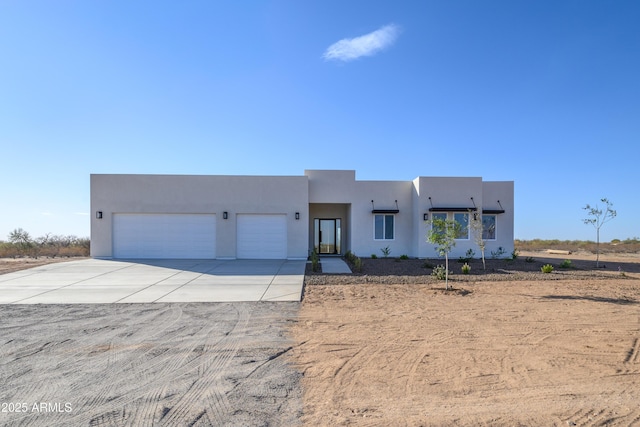 pueblo-style home featuring a garage