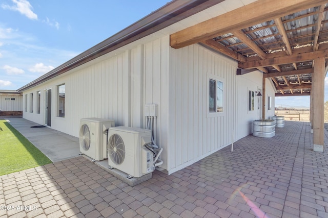 view of side of home with ac unit and a patio area