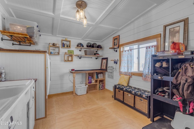 kitchen with wooden walls and light hardwood / wood-style floors