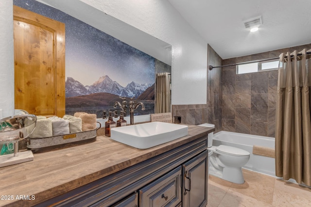 full bathroom featuring toilet, vanity, tile patterned floors, and shower / bathtub combination with curtain