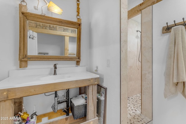 bathroom featuring sink and tiled shower