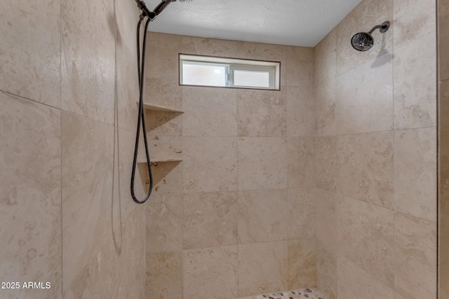 bathroom with a tile shower