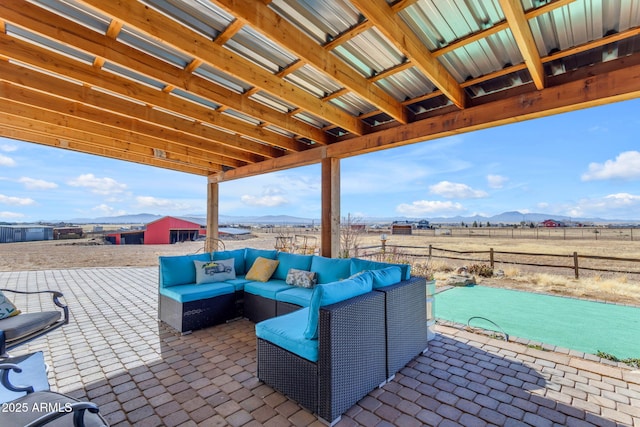 view of patio with a rural view, outdoor lounge area, and a mountain view