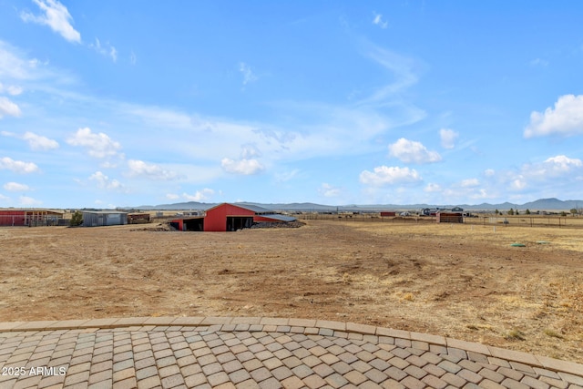 view of yard featuring a rural view and a mountain view