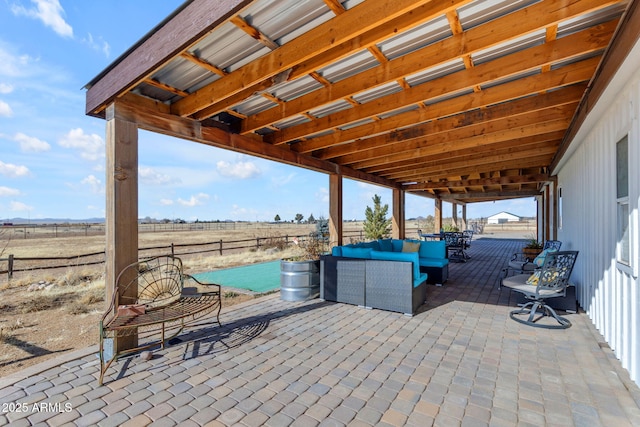 view of patio / terrace with an outdoor hangout area and a rural view