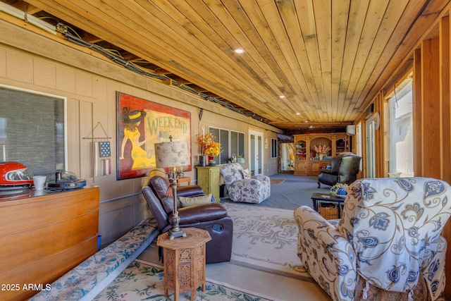 interior space featuring wood ceiling, wooden walls, and plenty of natural light