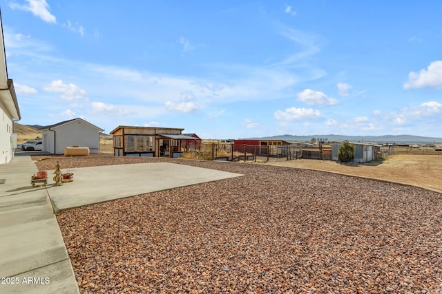 view of yard featuring a patio and a mountain view