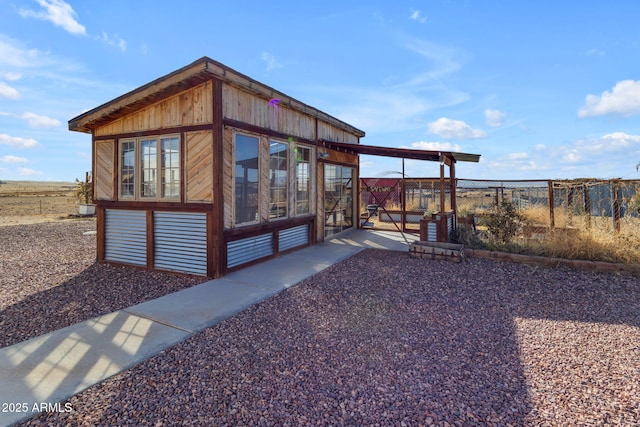 view of home's exterior with an outdoor structure