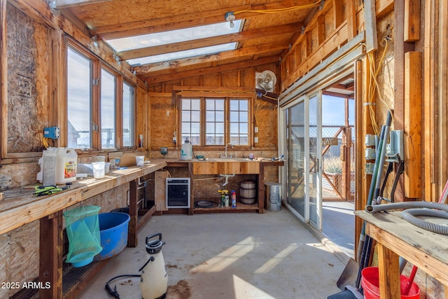 miscellaneous room featuring a workshop area, vaulted ceiling, and sink