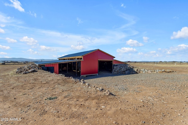 view of outdoor structure with a rural view