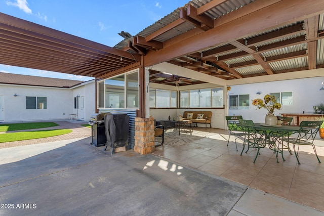 view of patio featuring ceiling fan, area for grilling, and an outdoor living space