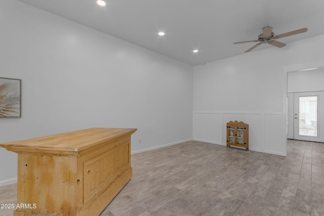 unfurnished room with ceiling fan and light hardwood / wood-style flooring