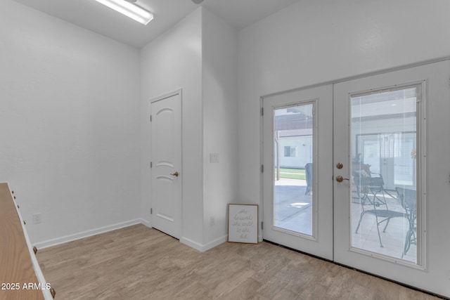 entryway featuring light wood-type flooring and french doors