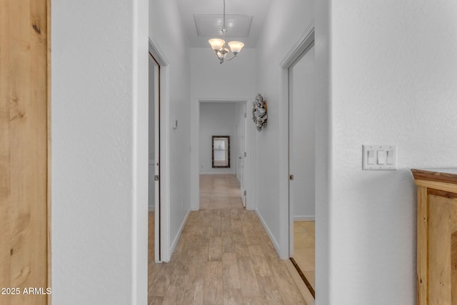 corridor with light hardwood / wood-style floors