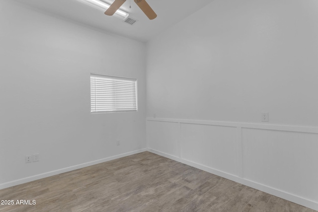 empty room with ceiling fan and light wood-type flooring