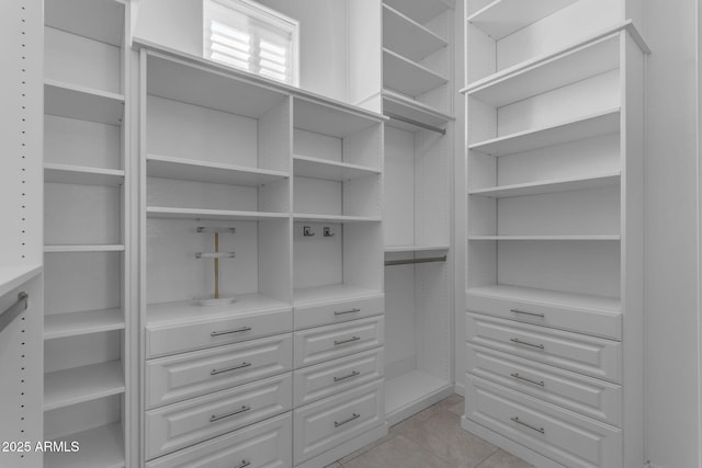 spacious closet with light tile patterned flooring