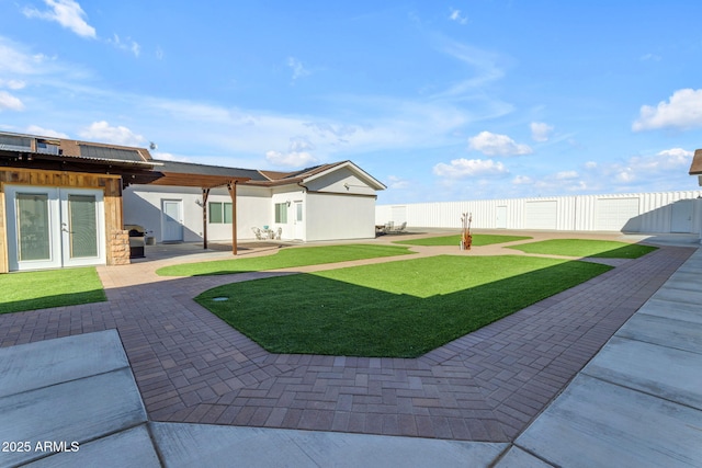 view of yard with french doors and a patio