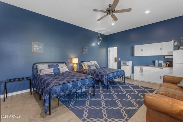 bedroom featuring ceiling fan and white fridge