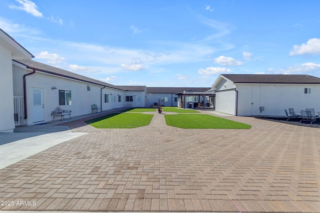 view of front facade with a patio area and a front lawn