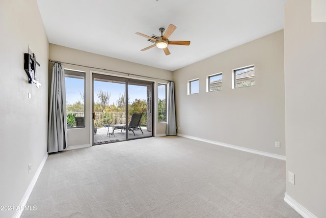 spare room with ceiling fan and light colored carpet