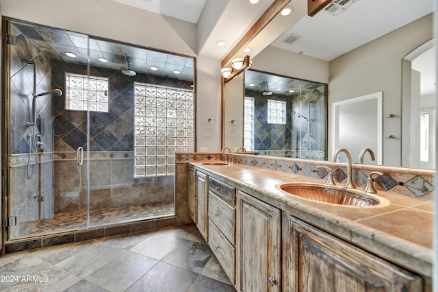 bathroom with vanity and a shower with door