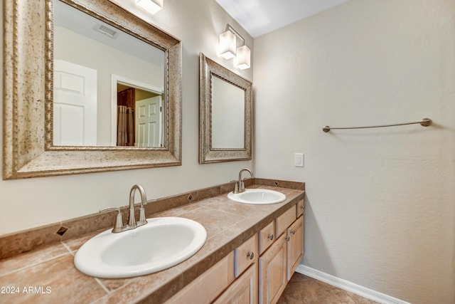 bathroom featuring tile patterned flooring and vanity