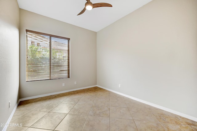 empty room with ceiling fan and light tile patterned floors