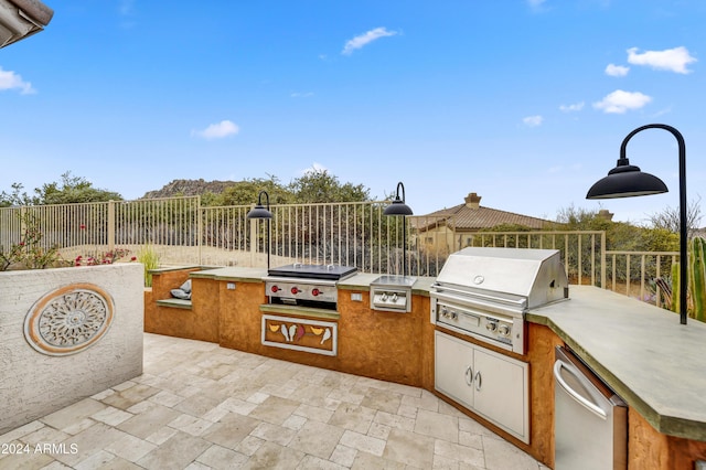 view of patio with area for grilling and a grill