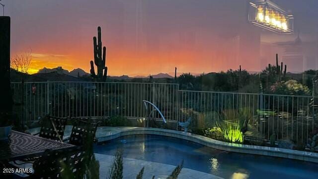 view of pool at dusk